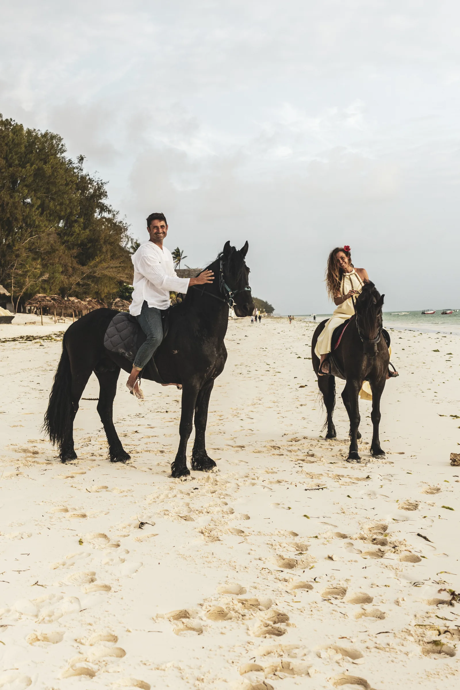 Couple riding on Paje beach at sunset, Zanzibar — the days around a wedding at The Nest