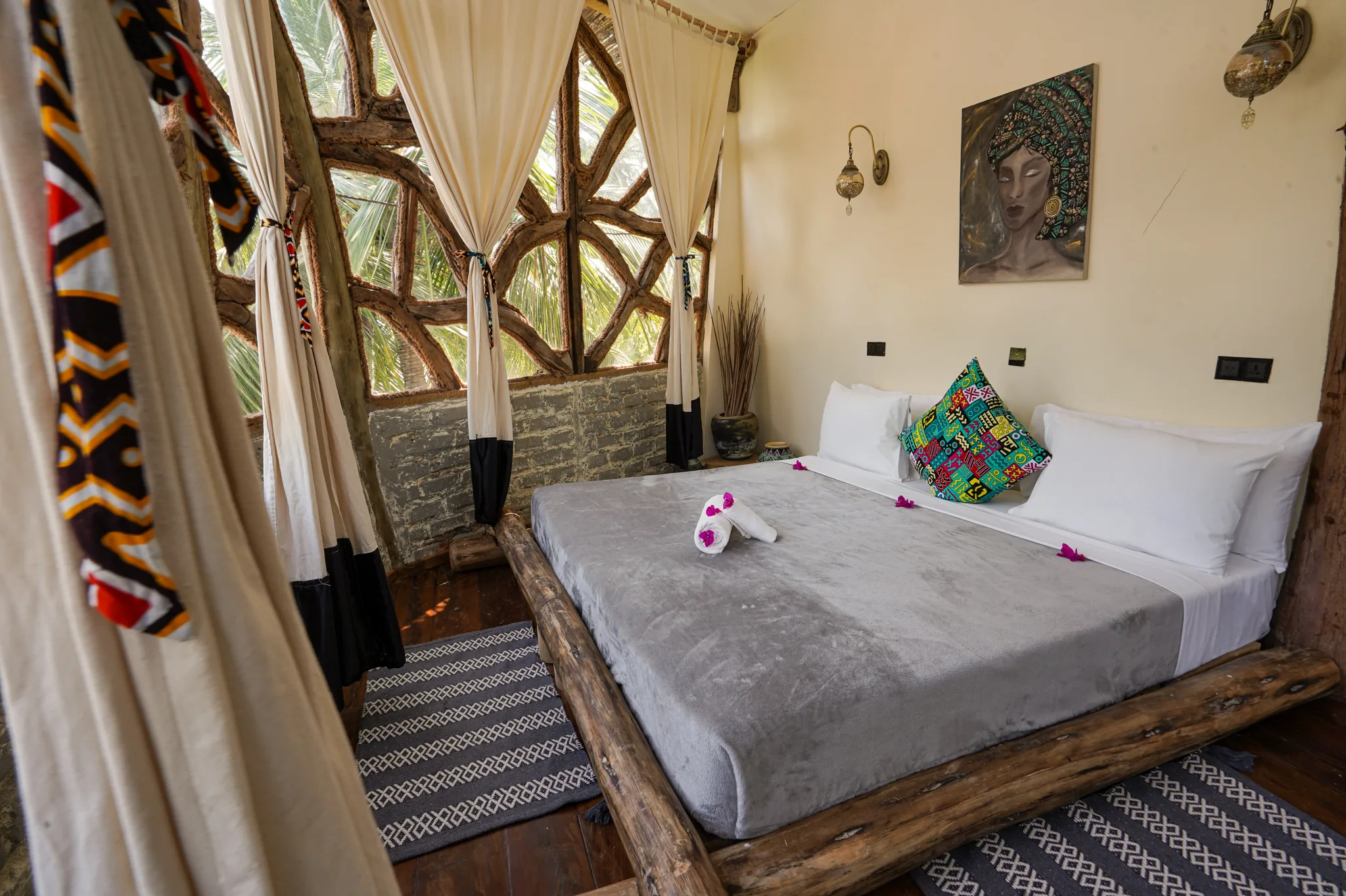 Tree House A-frame bedroom with makuti roof and king bed beneath a palm canopy