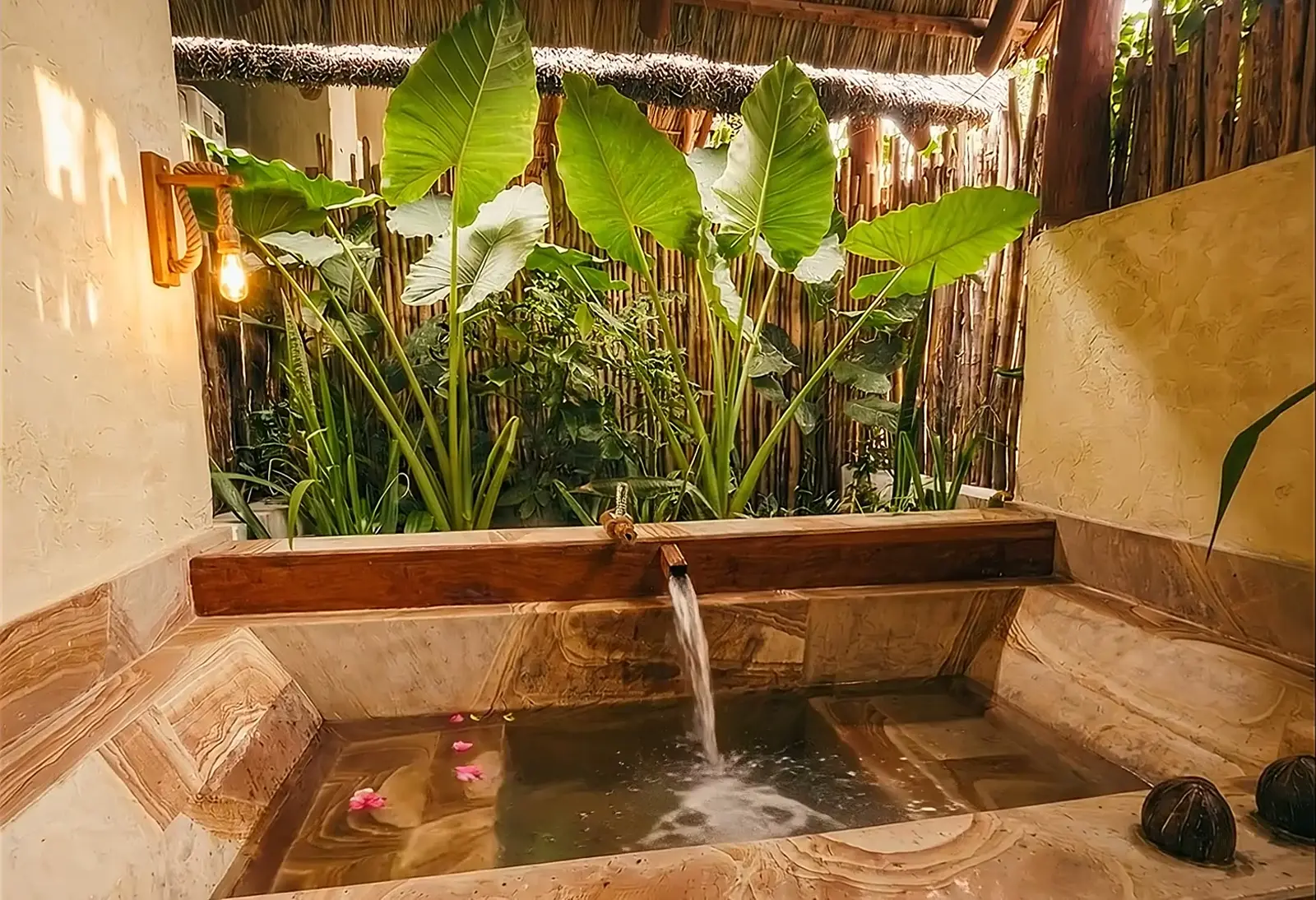 Bamboo-walled bathroom open to the greenery at a luxury boutique hotel in Zanzibar